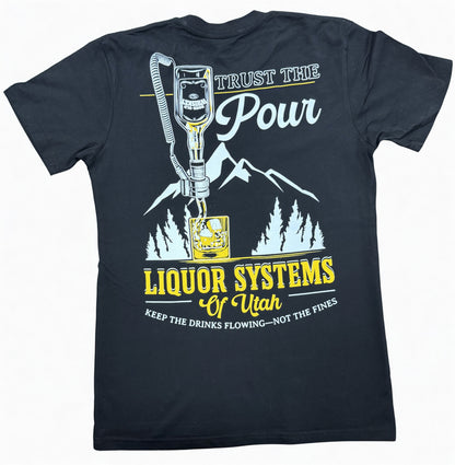 Black crew neck t-shirt, back view, with the words "Trust the Pour, Liquor Systems of Utah, Keep the drinks flowing - not the fines" surrounding a graphic of a liquor bottle pouring from a ring-type liquor dispensing device, with mountains in the background